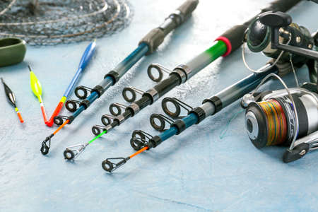 Different fishing equipment on color background