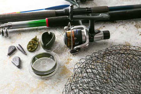 Different fishing equipment on light background