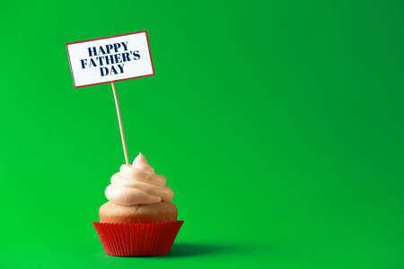 Tasty cupcake for Father's Day on color backgroundの写真素材