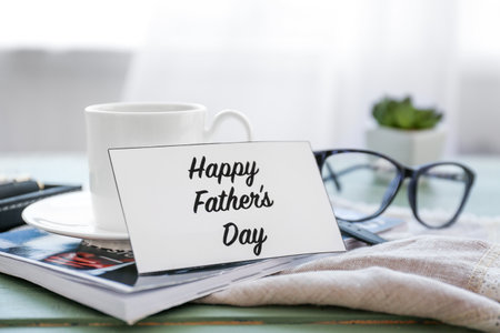 Cup of tea and greeting card for father on tableの写真素材