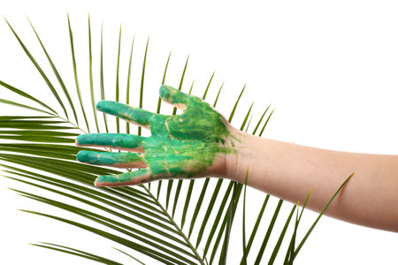 Painted female hand with tropical leaf on white backgroundの写真素材