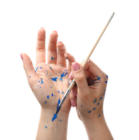 Painted female hands with brush on white backgroundの写真素材