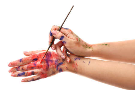 Painted female hands with brush on white backgroundの写真素材