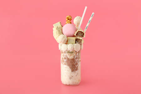 Glass with delicious freak shake on color backgroundの写真素材