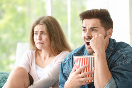 Couple watching scary movie at homeの写真素材