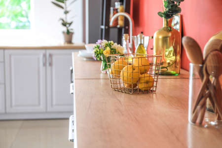 Basket with fresh lemons on counter in kitchen