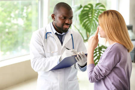 Woman meeting with plastic surgeon before operation in clinic