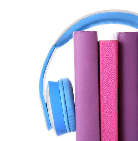 Books and modern headphones on white background. Concept of audiobookの写真素材