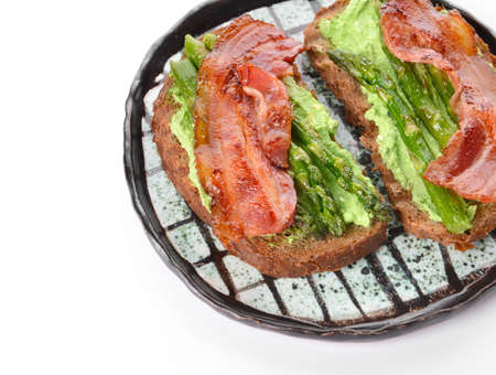 Plate with tasty toasts on white backgroundの写真素材