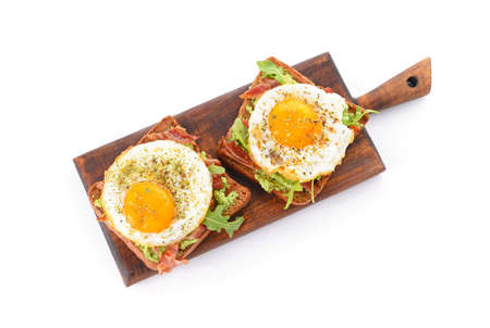 Board with tasty toasts on white backgroundの写真素材