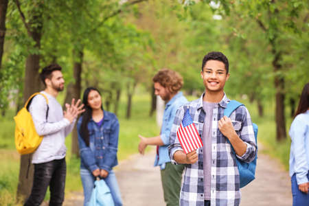 African-American student with USA flag outdoorsの写真素材