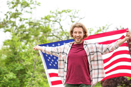 Male student with USA flag outdoorsの写真素材