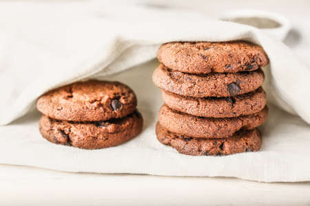 Tasty chocolate cookies on light table