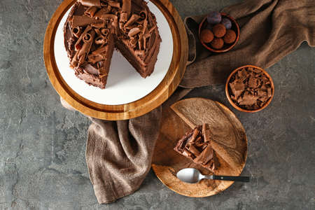 Tasty chocolate cake on grunge background
