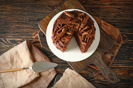 Tasty chocolate cake on wooden table