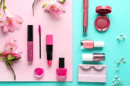 Set of decorative cosmetics and flowers on color backgroundの写真素材