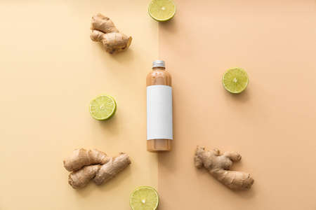 Bottle of shampoo, ginger and lime on color backgroundの写真素材