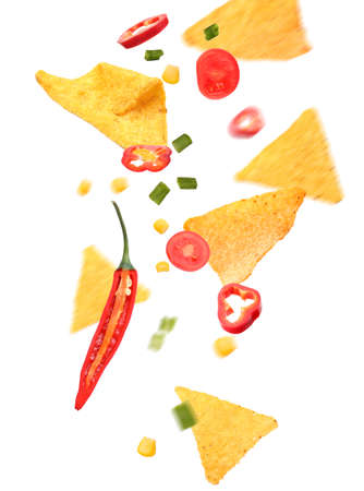 Flying nachos with ingredients on white backgroundの写真素材
