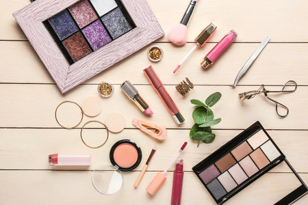 Set of decorative cosmetics and accessories on light wooden backgroundの写真素材