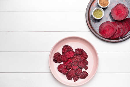Composition with tasty beet chips on tableの写真素材