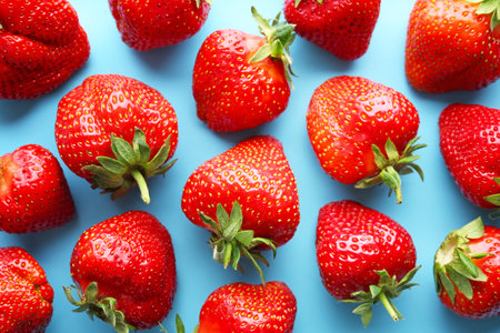 Ripe red strawberry on color backgroundの写真素材