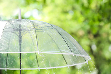 Transparent umbrella outdoors on rainy dayの写真素材
