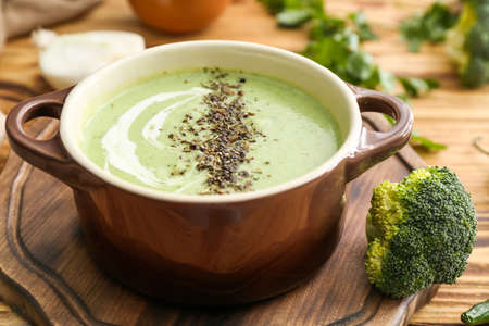 Pot of tasty cream soup on wooden tableの写真素材