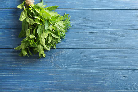 Bunch of fresh mint on wooden backgroundの写真素材