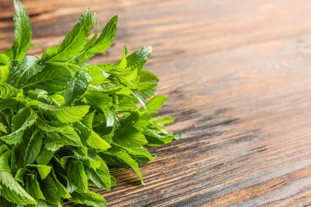 Bunch of fresh mint on wooden background, closeup