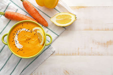 Pot of tasty cream soup and ingredients on tableの写真素材