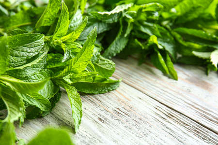 Fresh green mint on wooden background, closeup