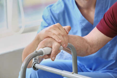 Elderly man with caregiver in nursing home, closeupの写真素材