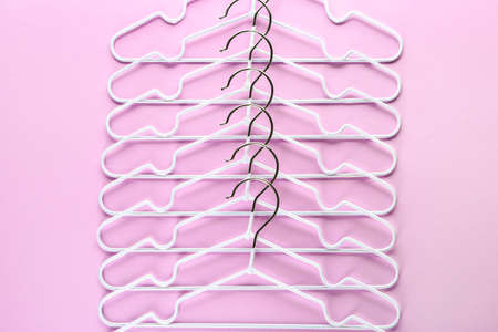 Many clothes hangers on color backgroundの写真素材