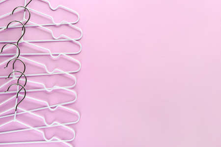 Many clothes hangers on color backgroundの写真素材