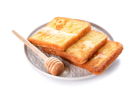 Plate with tasty French toasts and honey on white background