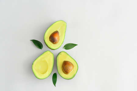 Halves of ripe avocado on white backgroundの写真素材