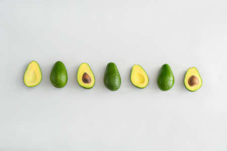 Fresh ripe avocados on white backgroundの写真素材