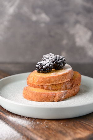 Plate with tasty French toasts and blackberry on tableの写真素材