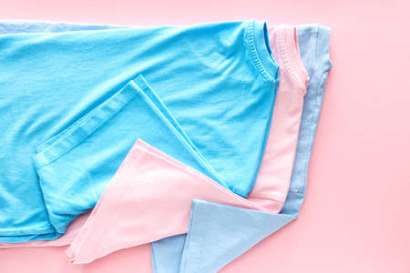 Different t-shirts on color backgroundの写真素材