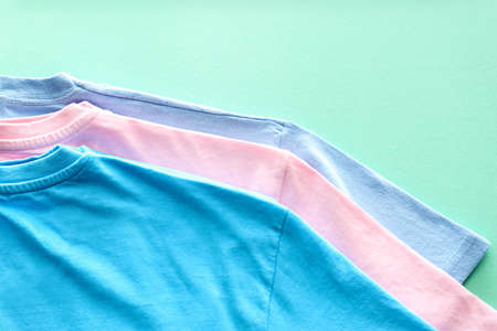 Different t-shirts on color backgroundの写真素材