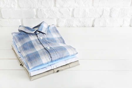 Stack of shirts on white tableの写真素材