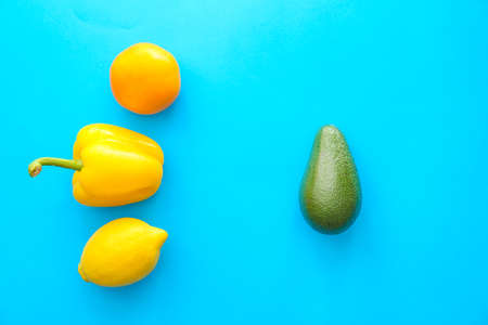 Fresh avocado and vegetables on color backgroundの写真素材
