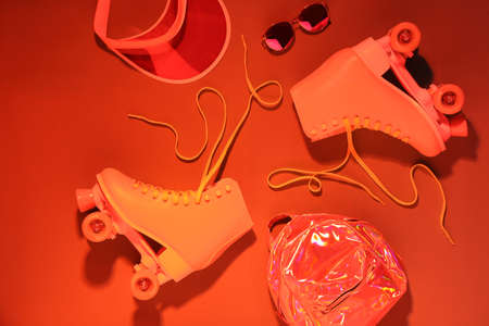 Composition with vintage roller skates on color backgroundの写真素材