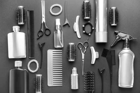 Set of hairdresser tools and accessories on dark background