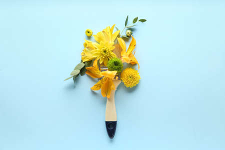 Beautiful composition with flowers and brush on color background