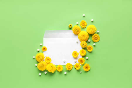 Beautiful composition with flowers and envelope on color background