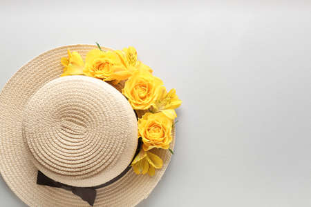 Beautiful flowers and hat on light backgroundの写真素材