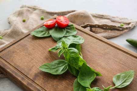 Fresh basil leaves on wooden boardの写真素材