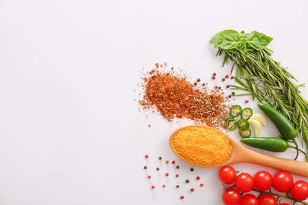 Spices with fresh vegetables and herbs on white backgroundの写真素材