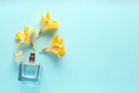Beautiful composition with flowers and perfume on color backgroundの写真素材